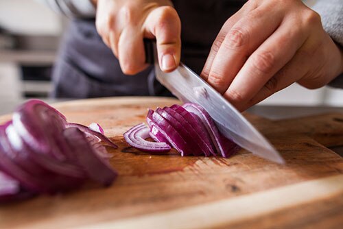 Slicing onion on cutting board